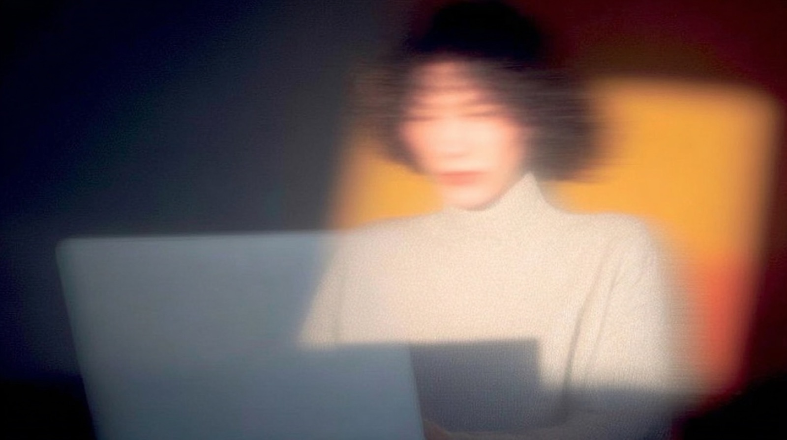 Editorial photograph with motion blur, figure in flowing garment against blue sky